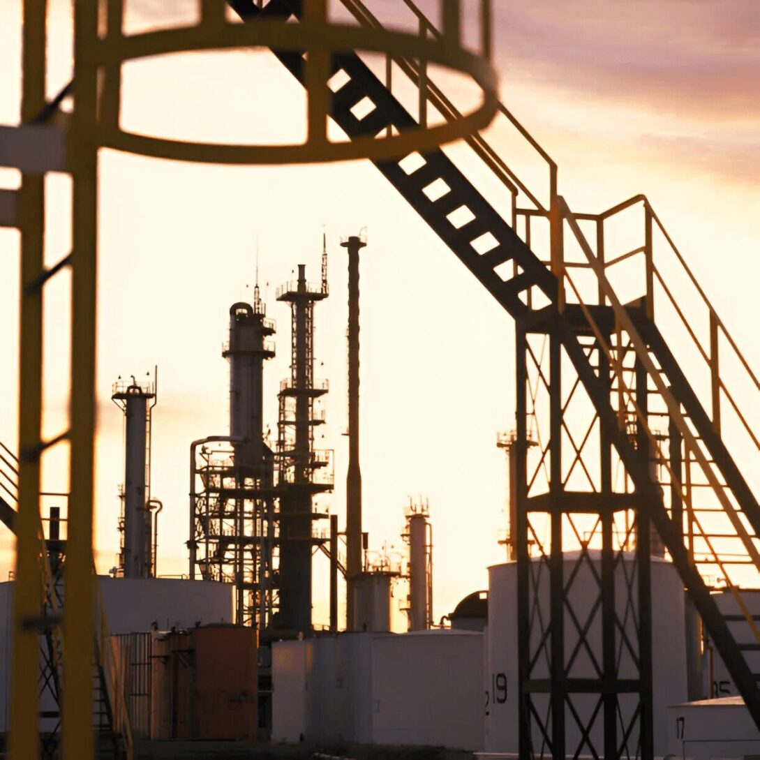 A view of an oil refinery at sunset.