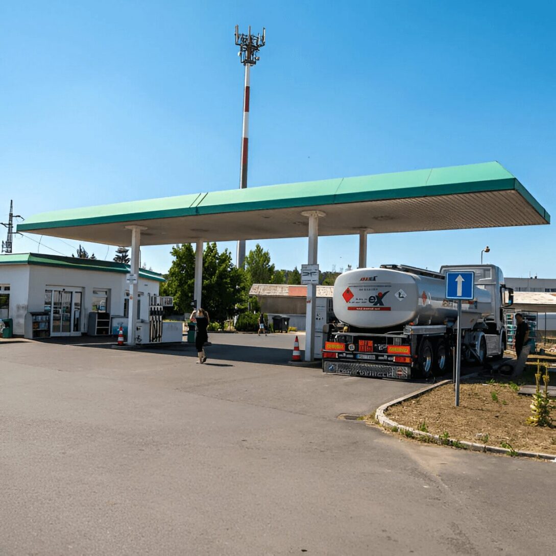 A gas station with a truck parked in front of it.